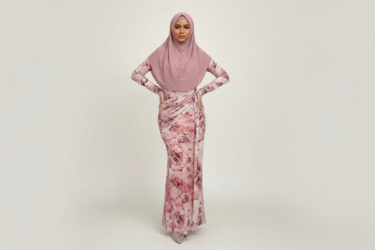 Woman wearing a pink floral dress in a kitchen setting