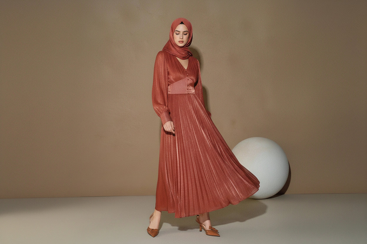 Woman wearing a rust-colored dress against a beige background