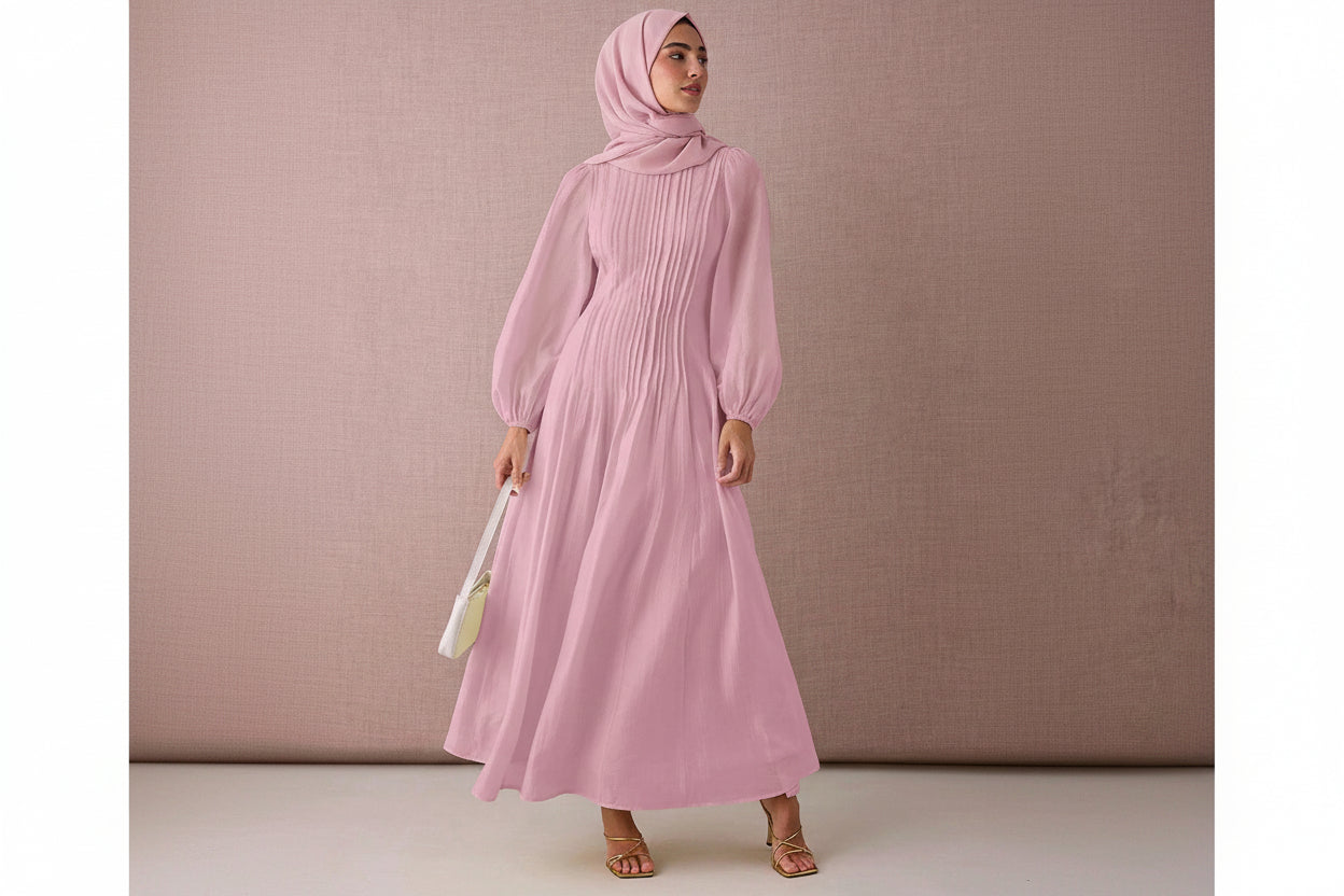 Woman wearing a pink dress against a pink background