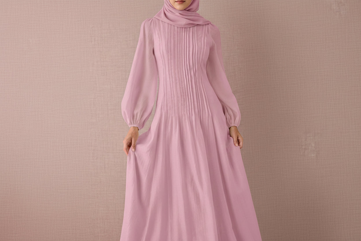 Pink ribbed dress with long sleeves on a beige background