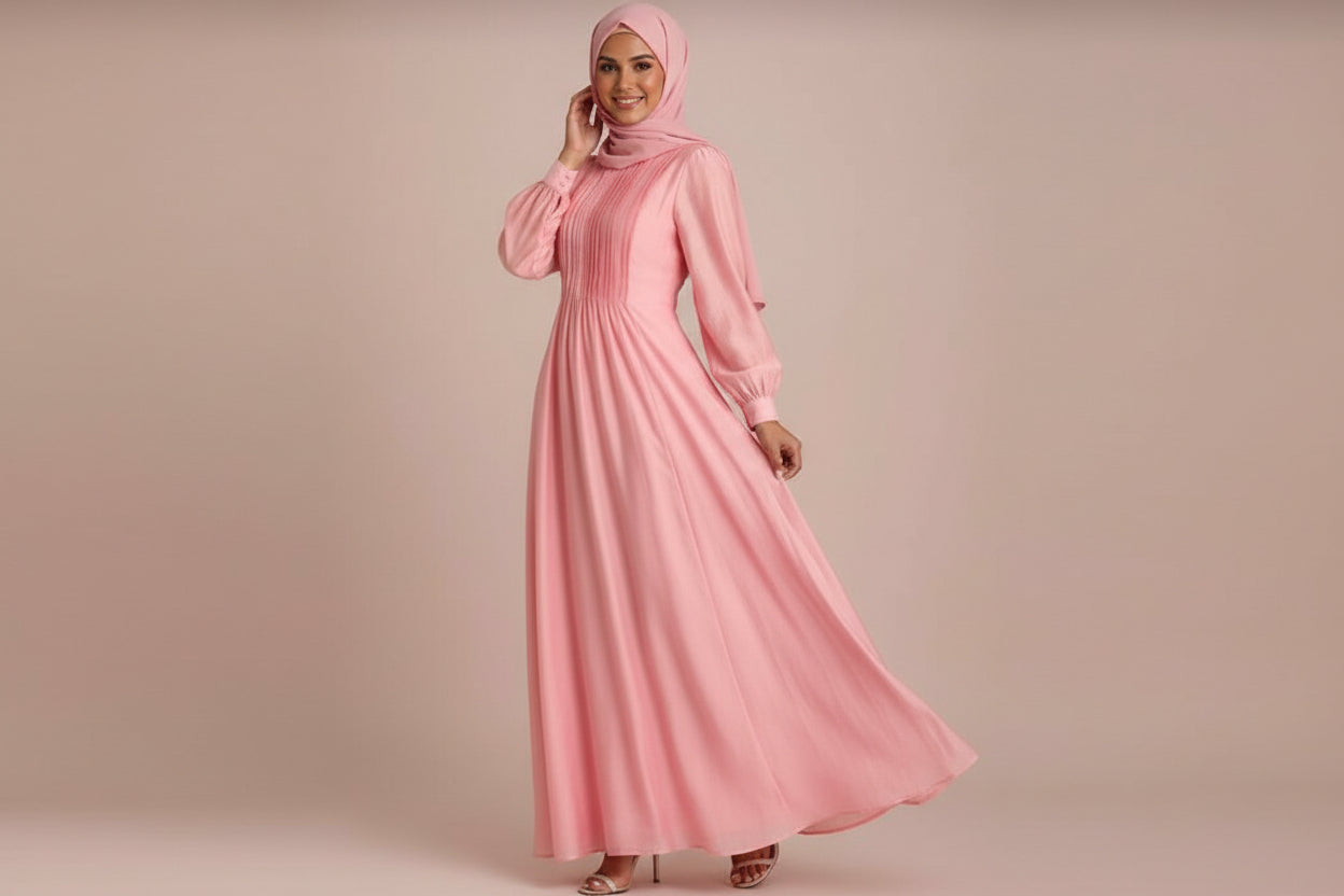 Woman wearing a pink dress against a plain background