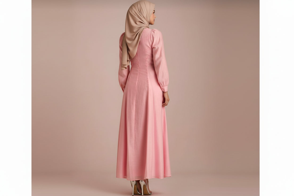 Woman wearing a pink dress against a beige background